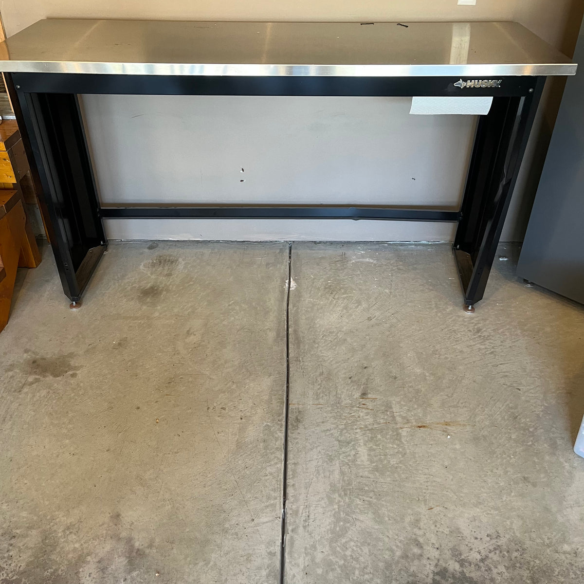X308 Husky metal worktable (dent in back panel)