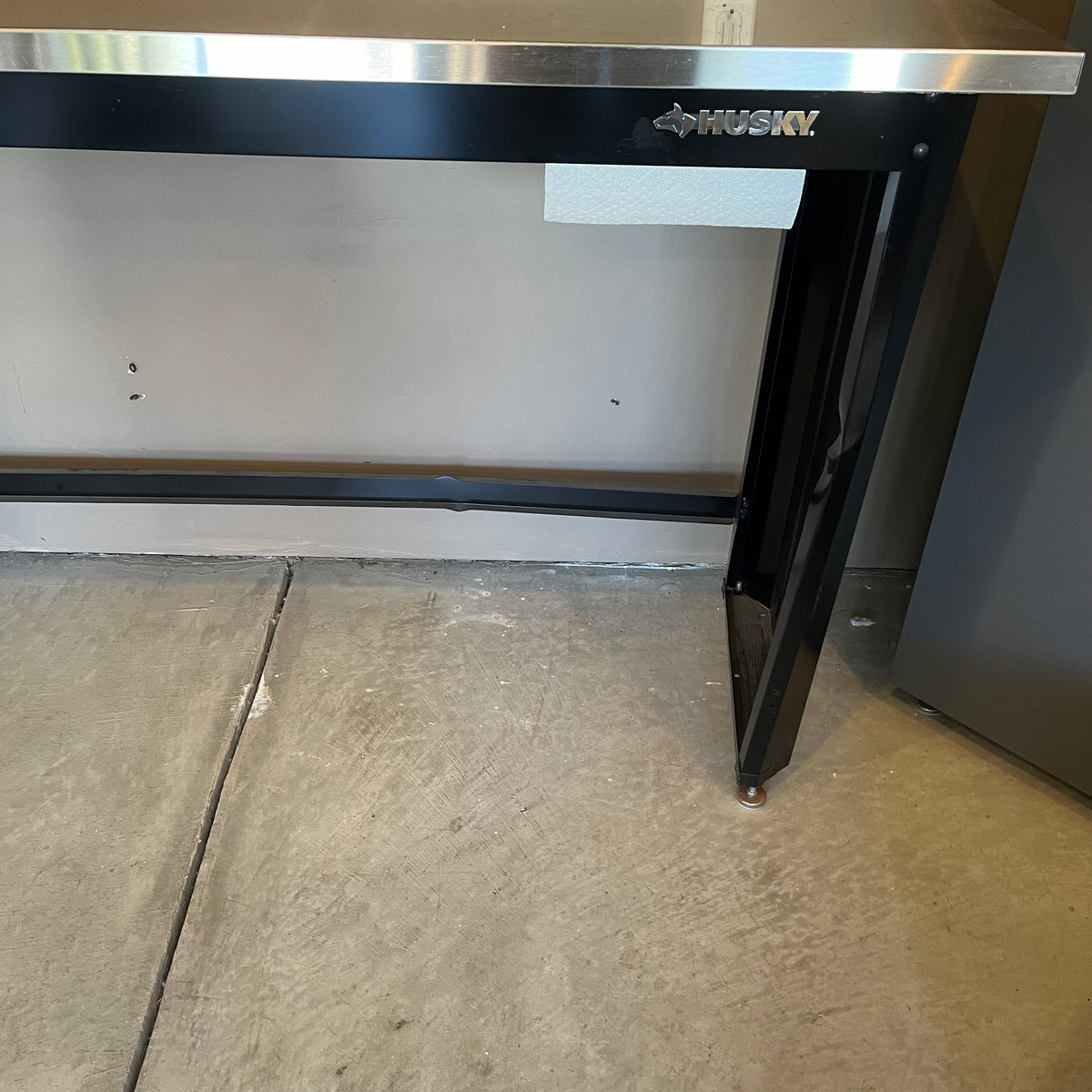 X308 Husky metal worktable (dent in back panel)