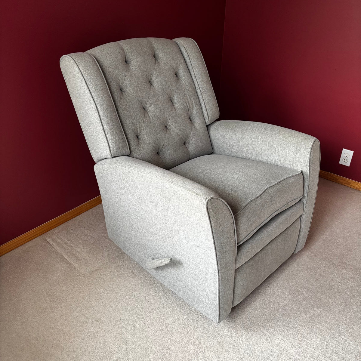 Y100 Grey fabric upholstered reclining/ rocking armchair (rip at far back of seat - visible only when reclined)