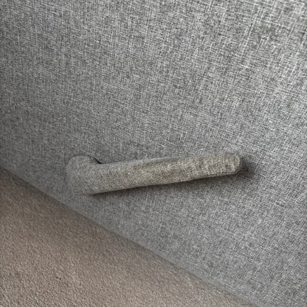Y100 Grey fabric upholstered reclining/ rocking armchair (rip at far back of seat - visible only when reclined)
