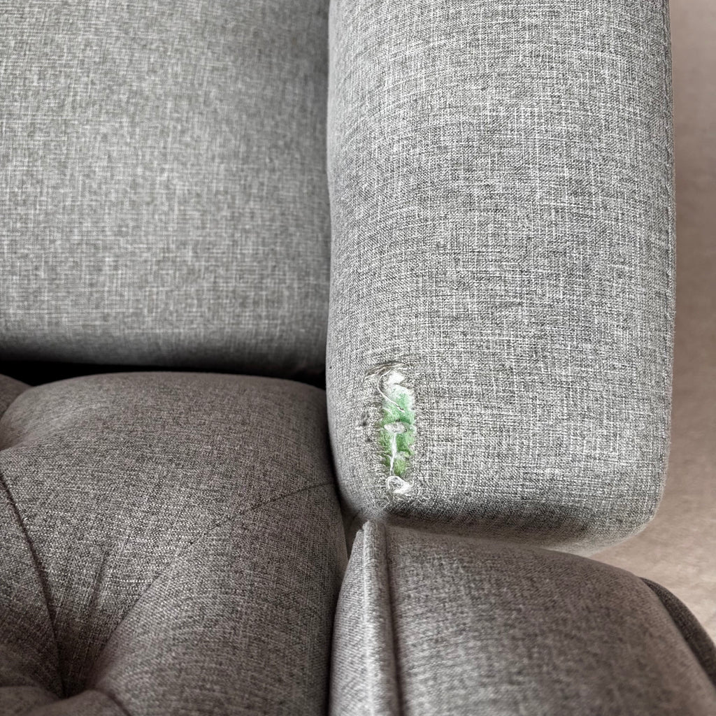 Y100 Grey fabric upholstered reclining/ rocking armchair (rip at far back of seat - visible only when reclined)