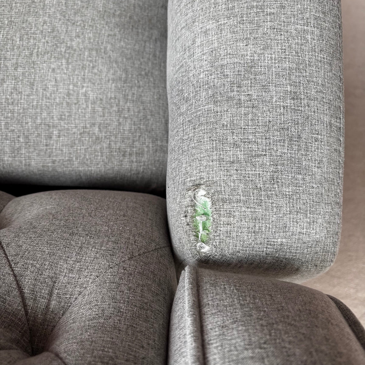 Y100 Grey fabric upholstered reclining/ rocking armchair (rip at far back of seat - visible only when reclined)