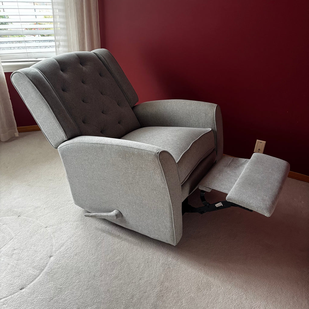 Y100 Grey fabric upholstered reclining/ rocking armchair (rip at far back of seat - visible only when reclined)