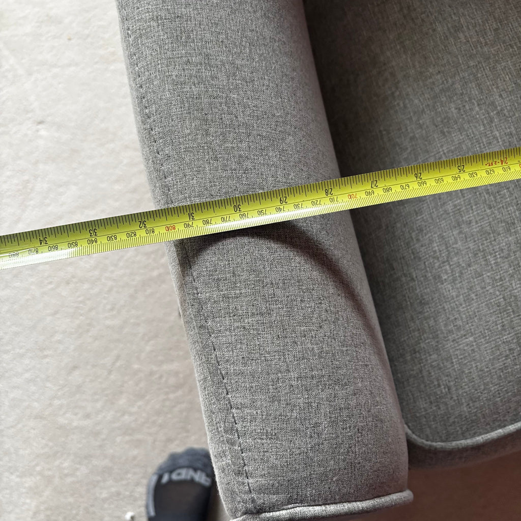 Y100 Grey fabric upholstered reclining/ rocking armchair (rip at far back of seat - visible only when reclined)