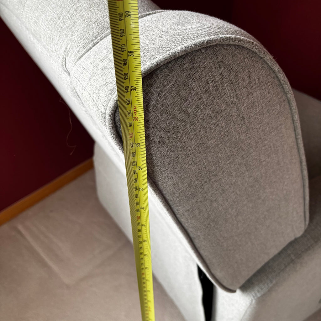 Y100 Grey fabric upholstered reclining/ rocking armchair (rip at far back of seat - visible only when reclined)