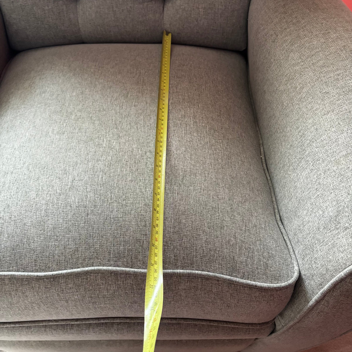 Y100 Grey fabric upholstered reclining/ rocking armchair (rip at far back of seat - visible only when reclined)