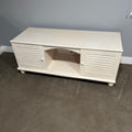 D306 Light colored wooden entertainment centre with storage (wear on top, 60" x 23" x 24")