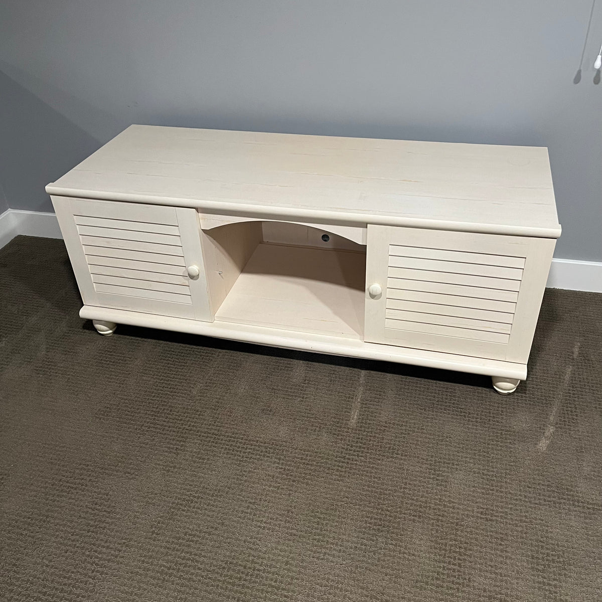 D306 Light colored wooden entertainment centre with storage (wear on top, 60" x 23" x 24")