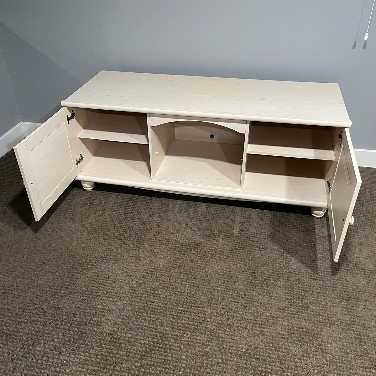 D306 Light colored wooden entertainment centre with storage (wear on top, 60" x 23" x 24")