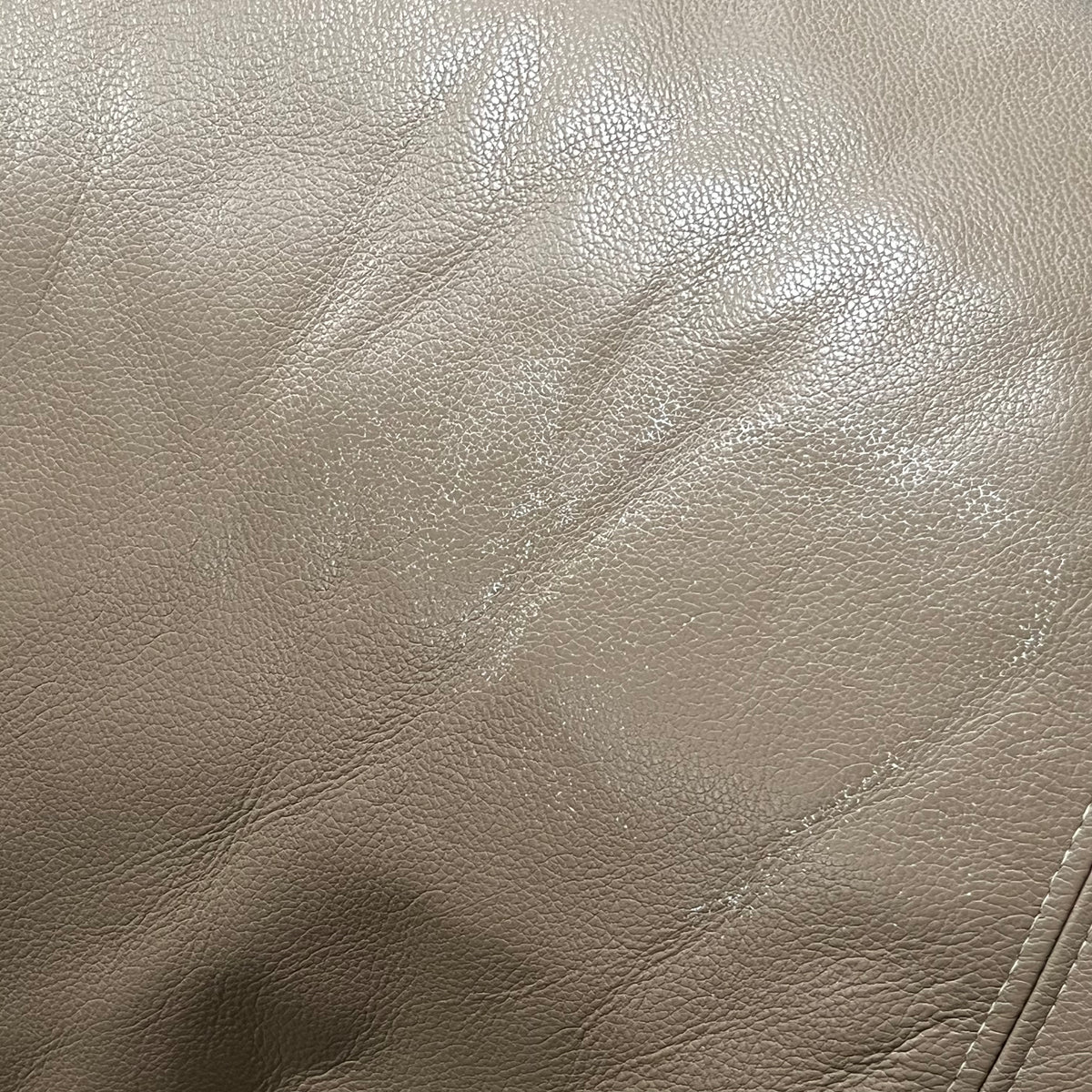 D319 Light beige leather reclining loveseat (wear on leather)