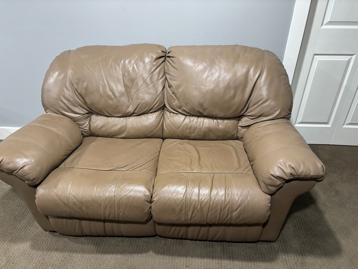 D217 Light beige leather reclining loveseat (wear on leather)