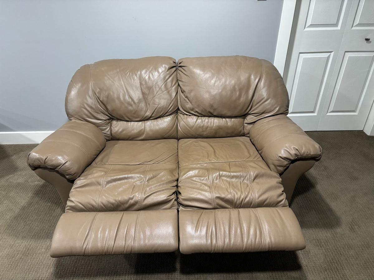 D217 Light beige leather reclining loveseat (wear on leather)