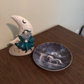 D171 Home Decor Grouping (half moon ceramic figurine and "Trails of Starlight" plate)