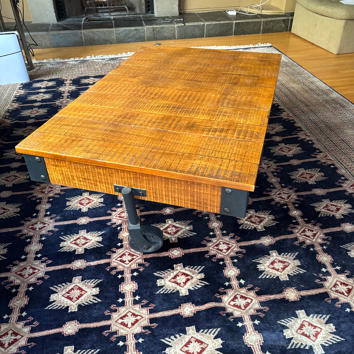 E128 Coffee table with industrial wheels (16” x 47” x 31”) **one wheel is slightly bent