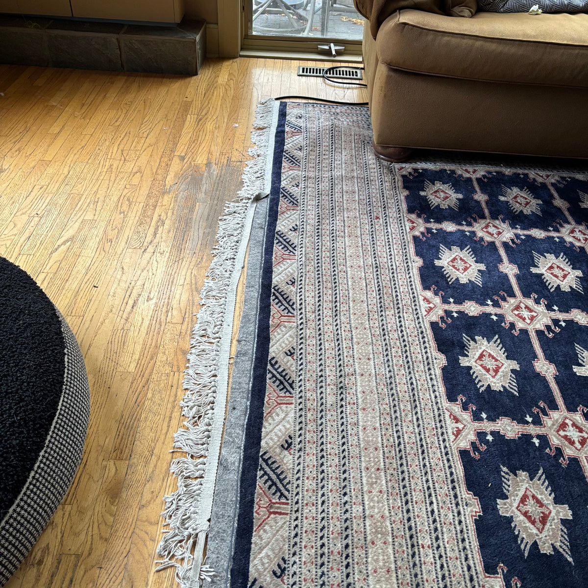 E129 109” x 150” Vintage wool rug with underlay (fringe is mostly separated)