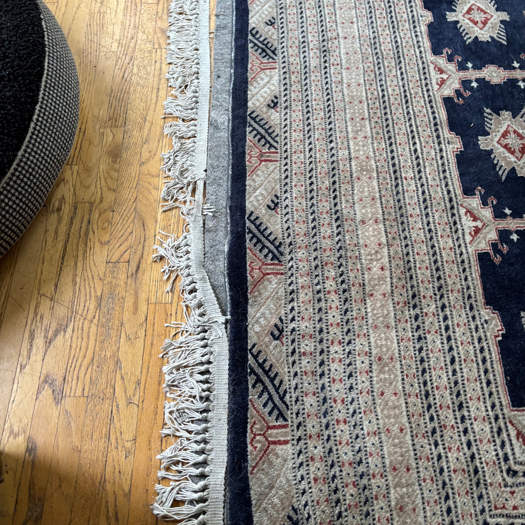 E129 109” x 150” Vintage wool rug with underlay (fringe is mostly separated)