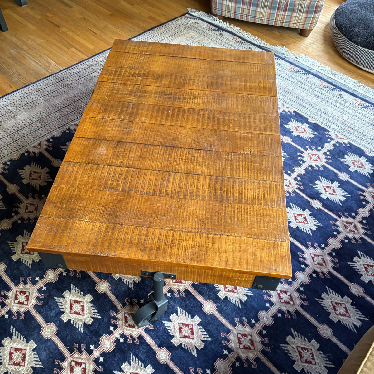 E128 Coffee table with industrial wheels (16” x 47” x 31”) **one wheel is slightly bent