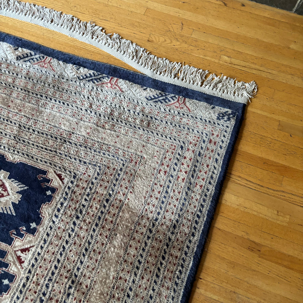 E129 109” x 150” Vintage wool rug with underlay (fringe is mostly separated)