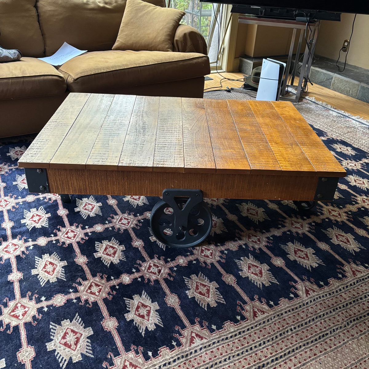 E128 Coffee table with industrial wheels (16” x 47” x 31”) **one wheel is slightly bent