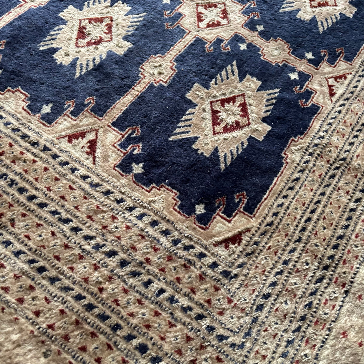 E129 109” x 150” Vintage wool rug with underlay (fringe is mostly separated)