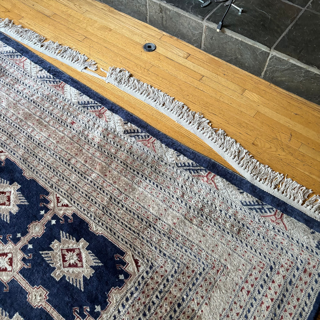 E129 109” x 150” Vintage wool rug with underlay (fringe is mostly separated)