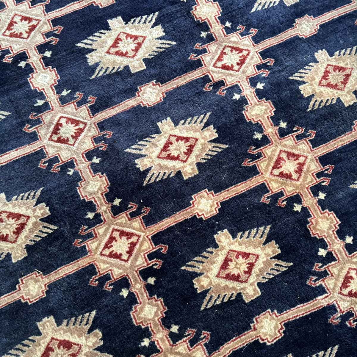 E129 109” x 150” Vintage wool rug with underlay (fringe is mostly separated)
