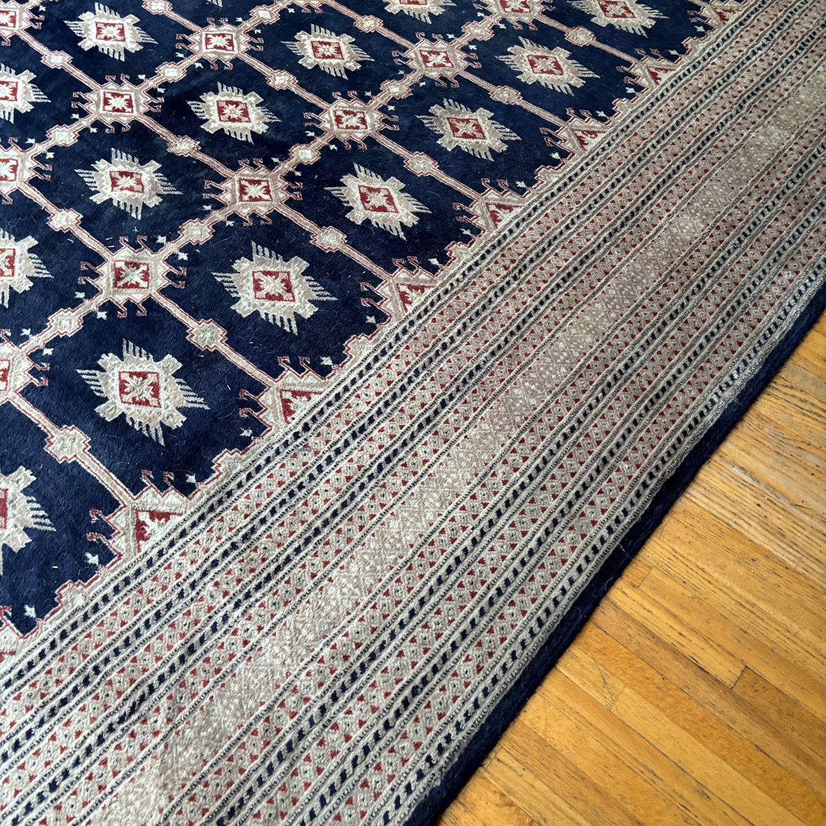 E129 109” x 150” Vintage wool rug with underlay (fringe is mostly separated)