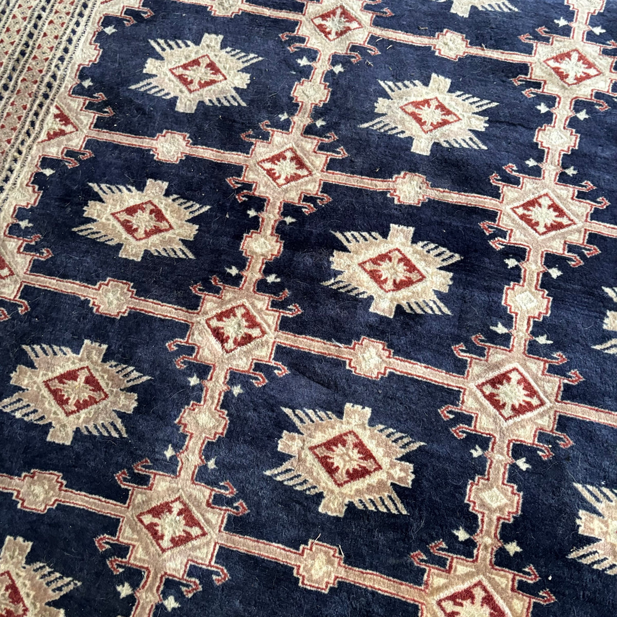 E129 109” x 150” Vintage wool rug with underlay (fringe is mostly separated)